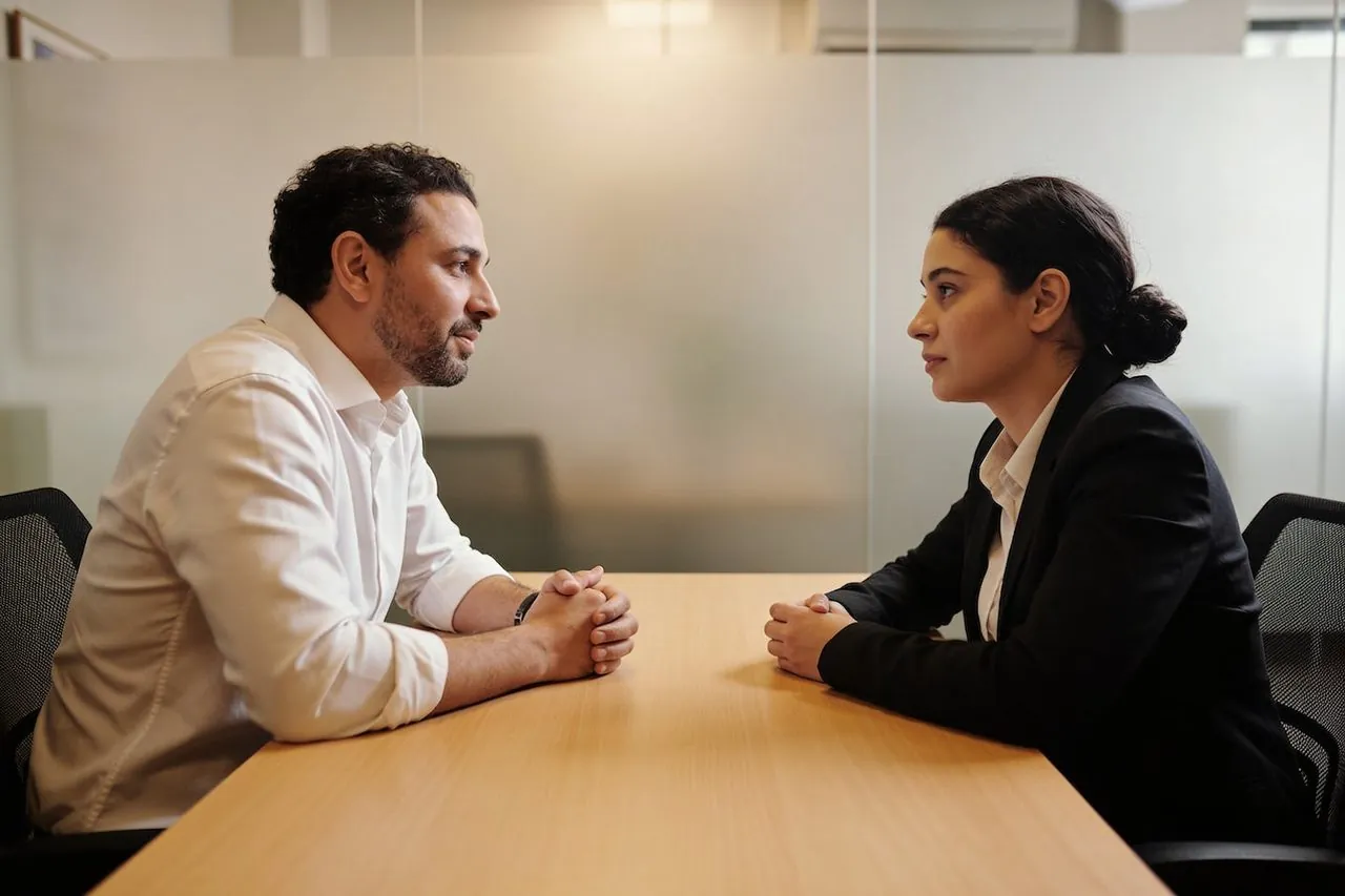 Business owner and employee having a one-on-one conversation in an office