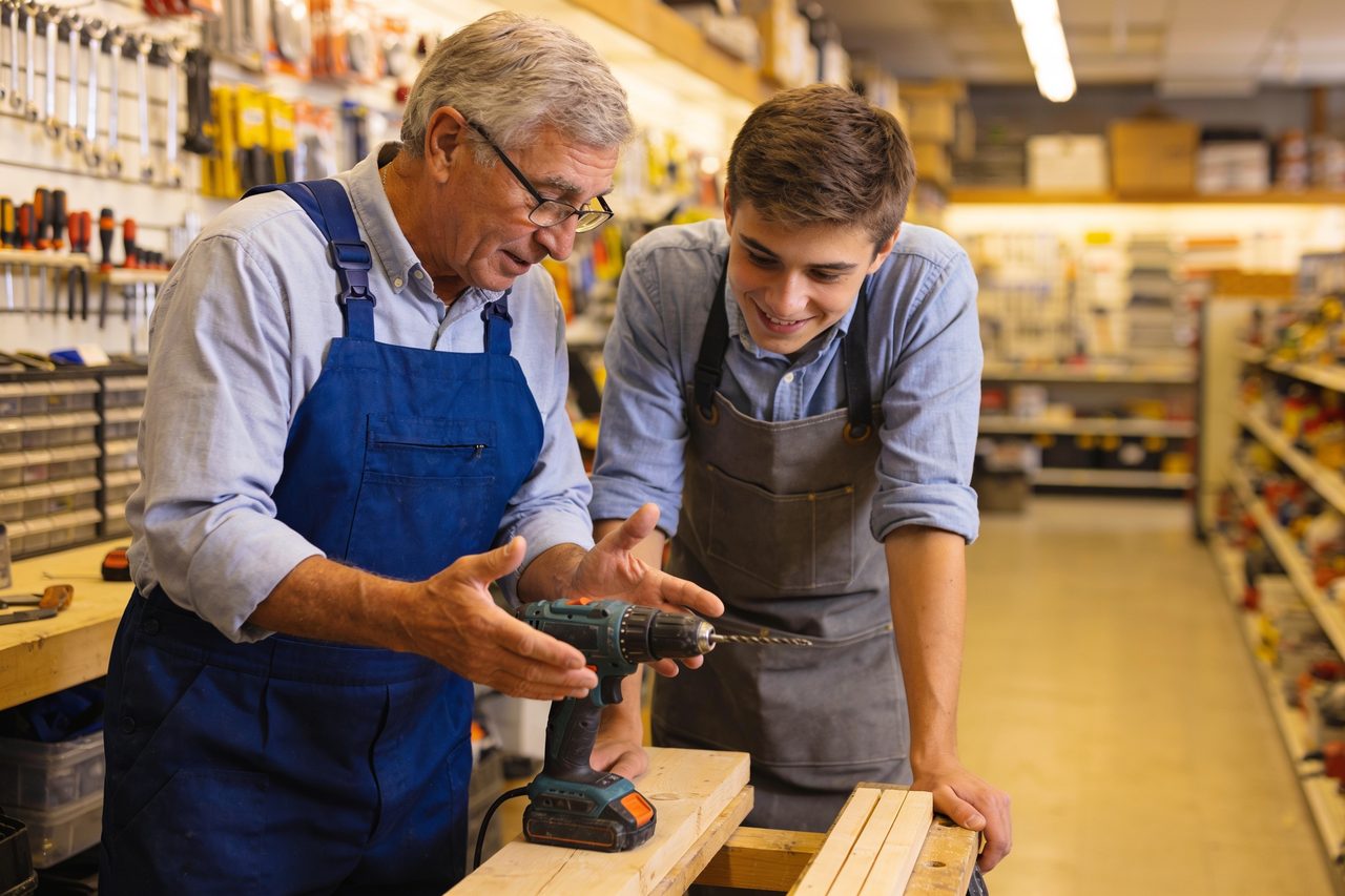 Small business owner welcoming and training a new team member on their first day - how to onboard a new employee.